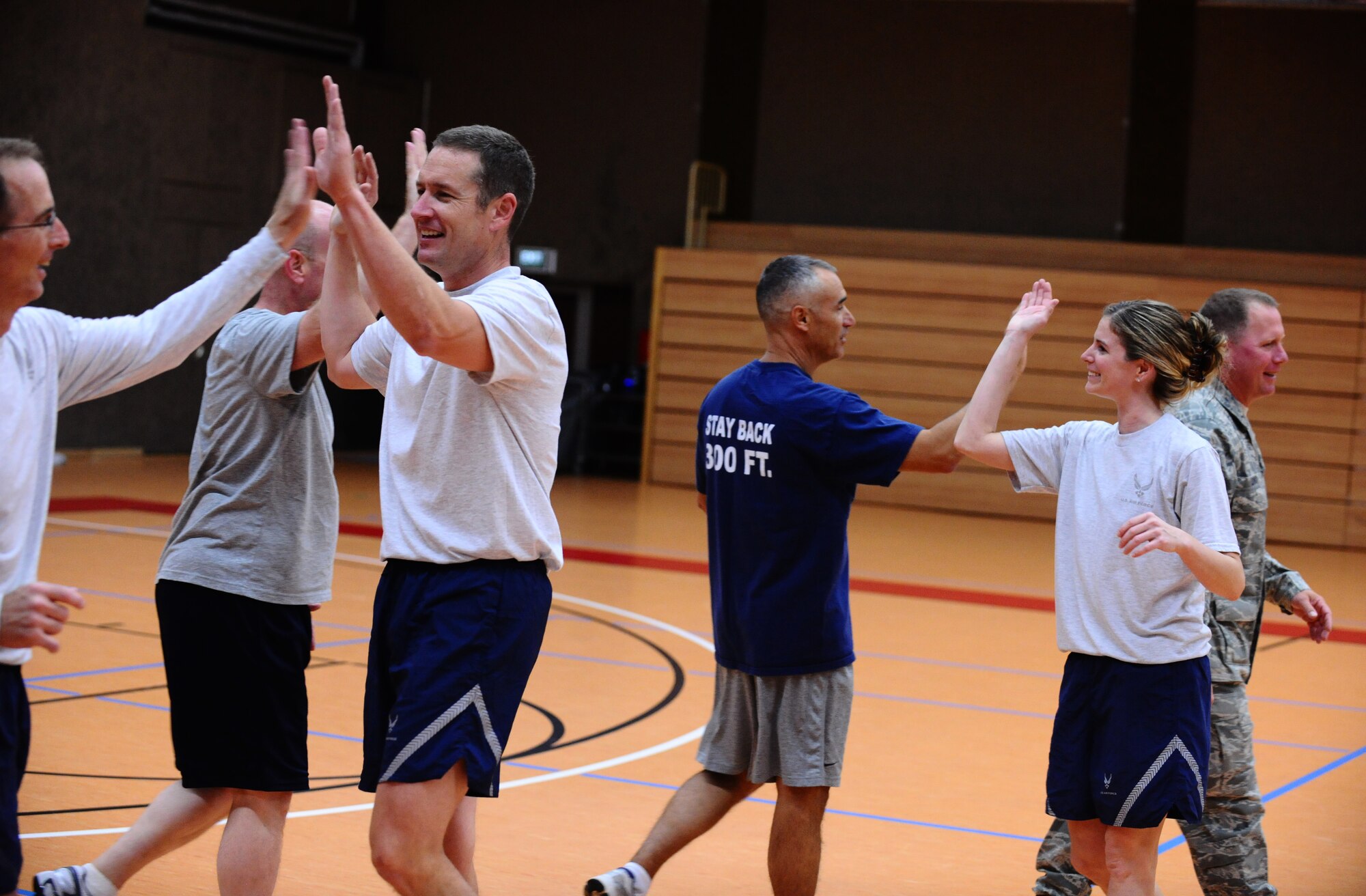 SPANGDAHLEM AIR BASE, Germany -- Members of the Spangdahlem Chiefs and Spangdahlem Commanders congratulate each other at the end of a volleyball match at the Skelton Memorial Fitness Center here Aug. 30. The Chiefs defeated the Commanders 15-12 the first game and 15-3 the second game. (U.S. Air Force photo/Staff Sgt. Nathanael Callon)