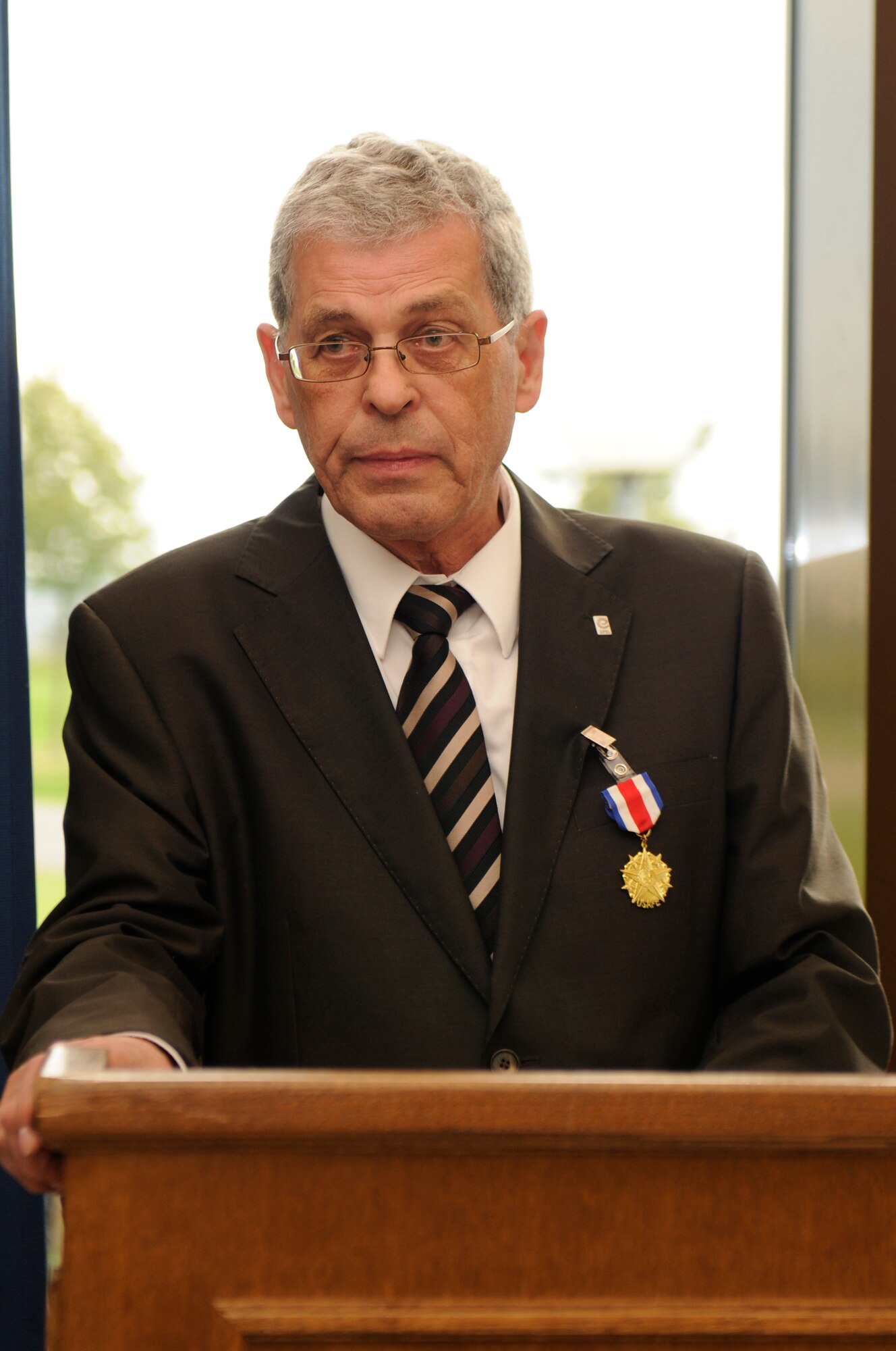 SPANGDAHLEM AIR BASE, Germany -- Mr. Roger Graef, commissioner for the Bitburg-Prüm County, gives a speech after receiving the U.S. Air Forces in Europe Medal of Distinction at Club Eifel here Sept. 6 from Col. Christopher Weggeman, 52nd Fighter Wing commander,. The USAFE Medal of Distinction is the highest medal awarded to host nation partners. According to his citation, Graef has been a positive influence in the advancement of German-American relations and has created closer ties between USAFE Airmen and host- nation citizens. (U.S. Air Force photo/Airman 1st Class Brittney Frees)