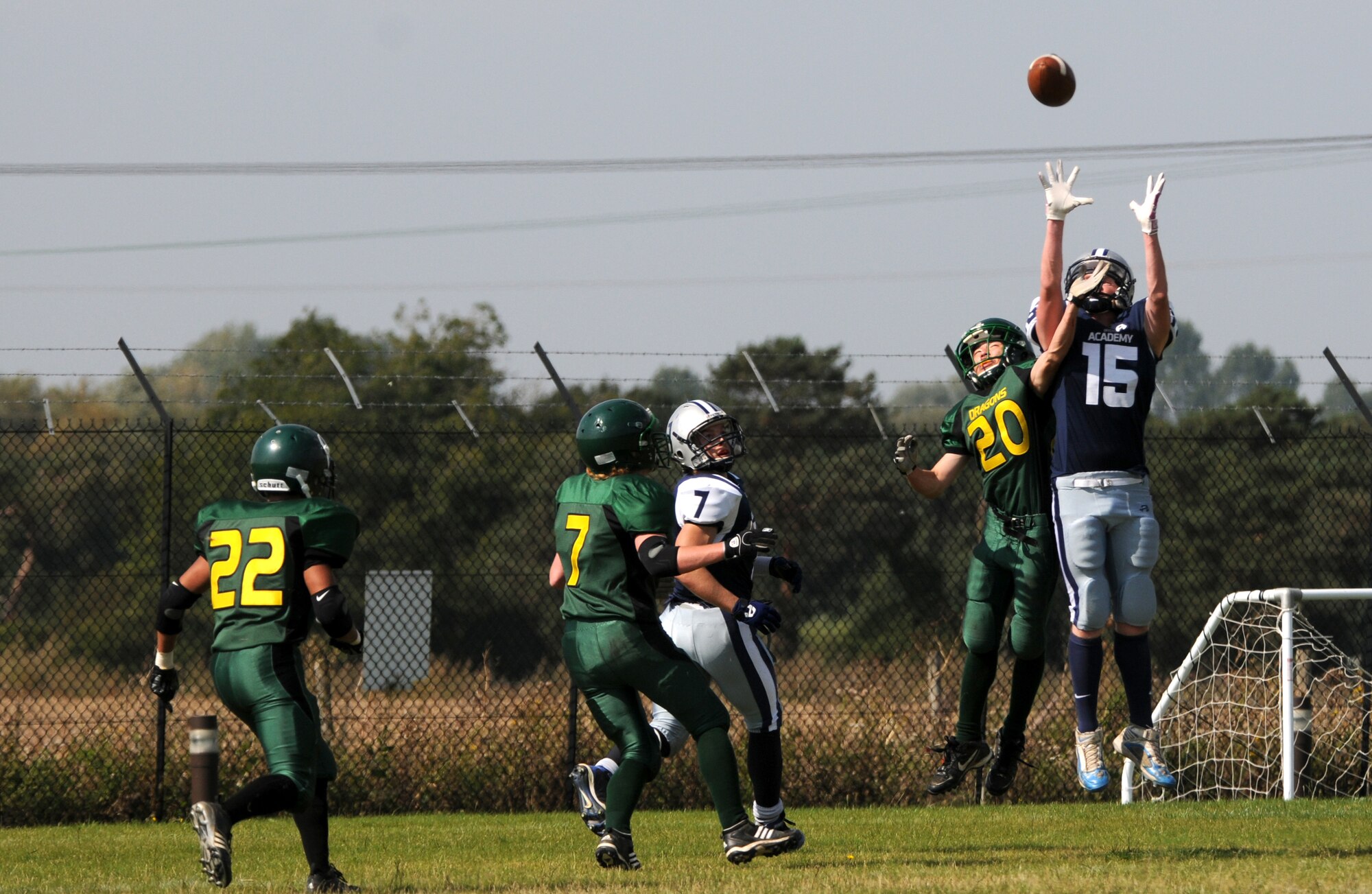 ROYAL AIR FORCE LAKENHEATH, England - Nicky Farrel, Bristol Academy Pride wide reciever, leaps to catch a pass while under heavy coverage from the Alconbury High School Dragon's defense on RAF Lakenheath, Sept. 9, 2011.  American high school teams as well as the British Bristol Academy Pride football team competed in several scrimmages designed to build camaraderie and practice real game like scenarios.  (U.S. Air Force photo/Airman Cory Payne)