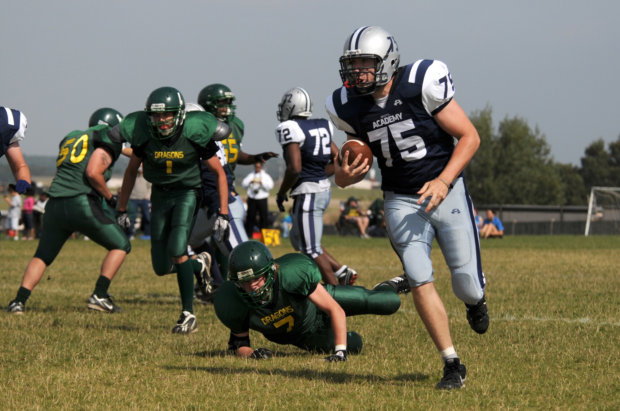 ROYAL AIR FORCE LAKENHEATH, England - Elliot Menahon, Bristol Academy Pride halfback, runs against the Alconbury High School Dragon's defense on RAF Lakenheath, Sept. 9, 2011.  American high school teams as well as the British Bristol Academy Pride football team competed in several scrimmages designed to build camaraderie and practice real game-like scenarios.  (U.S. Air Force photo/Airman Cory Payne)