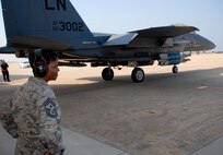 KUNSAN AIR BASE, Republic of Korea -- Chief Master Sgt. SaRita Lathan, 48th Fighter Wing command chief, watches as an F-15 Strike Eagle from the 48th FW, RAF Lakenheath, England, launches during her visit here Sept. 2. (U.S. Air Force photo/ Senior Airman Benjamin Stratton)