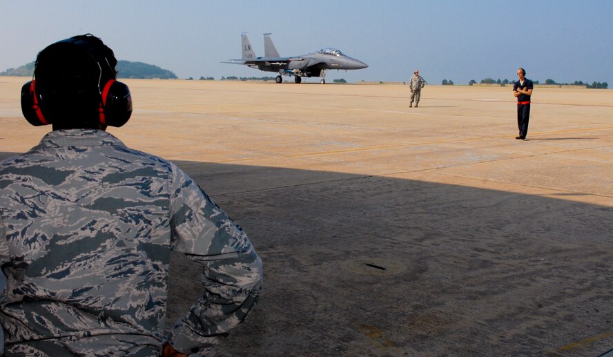 KUNSAN AIR BASE, Republic of Korea -- Chief Master Sgt. SaRita Lathan, 48th Fighter Wing command chief, watches as an F-15 Strike Eagle from the 48th FW, RAF Lakenheath, England, launches during her visit here Sept. 2. (U.S. Air Force photo/ Senior Airman Benjamin Stratton)