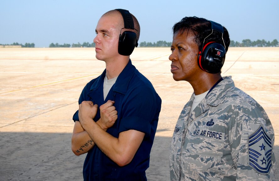 KUNSAN AIR BASE, Republic of Korea -- Staff Sgt. Jacob Mitchell, 494th Aircraft Maintenance Unit crew chief, waits for an F-15 Strike Eagle from the 48th Fighter Wing, RAF Lakenheath, England, as they complete final launch procedures as Chief Master Sgt. SaRita Lathan, 48th Fighter Wing command chief, looks on during her visit from here Sept. 2. (U.S. Air Force photo/ Senior Airman Benjamin Stratton)