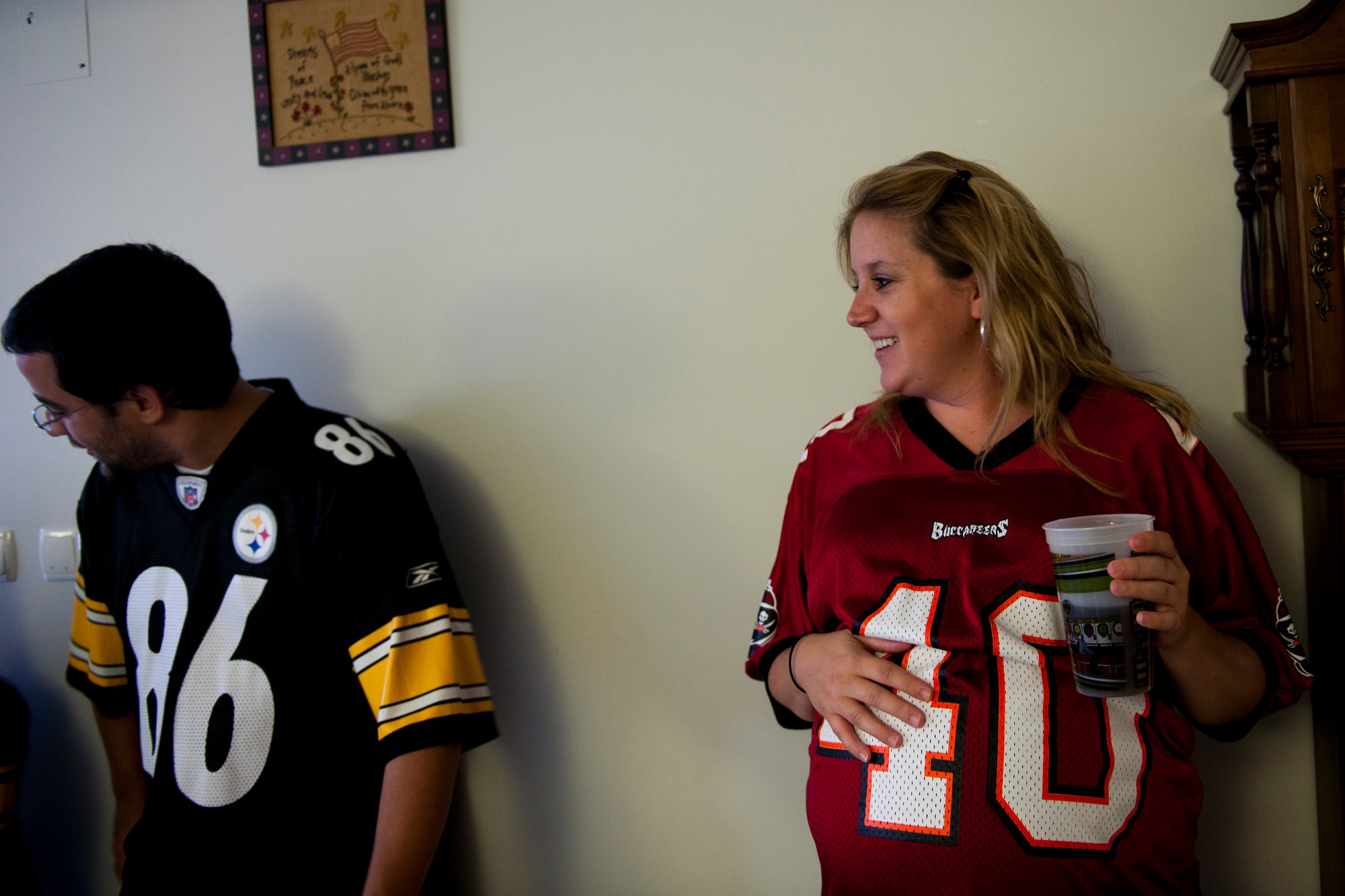 Lyndsey Derogatis, right, laughs while Greg Strickland waits to select players during a fantasy football draft Sept. 2, 2011, at Incirlik Air Base, Turkey. Fantasy drafts can be online, but a group of Incirlik Airmen, spouses and contractors decided to participate in a live draft. This type offers participants an opportunity to socialize and build camaraderie. (U.S. Air Force photo by Tech. Sgt. Michael B. Keller/Released)