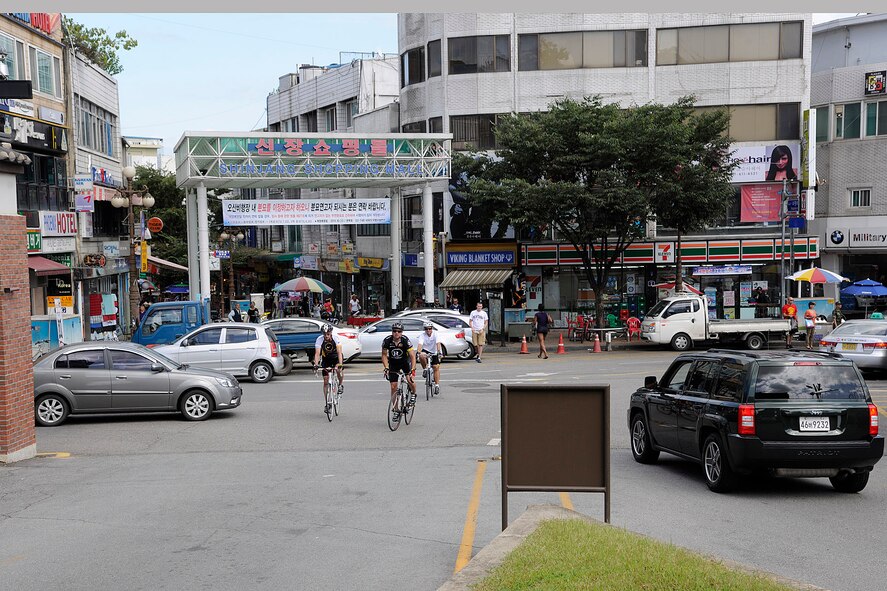 OSAN AIR BASE, Republic of Korea -- Three 8th Maintenance Squadron Airmen finish their ride as they approach the Osan AB main gate following a more than 105 mile trek from Kunsan AB to Osan AB here Sept. 3 in support of The Lance Armstrong Foundation and to increase cancer awareness. The cycling trio raised more than $1,300 for the Combined Federal Campaign charity. (U.S. Air Force photo/Staff Sgt. Rasheen Douglas)
