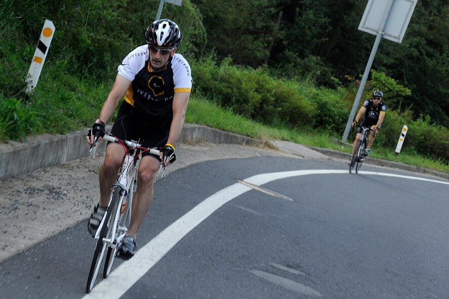 KUNSAN AIR BASE, Republic of Korea -- Master Sgt. Paul Branstetter, 8th Maintenance Squadron precision guided munitions NCO in charge, is followed by Tech. Sgt. Marc Sellers, 8th MXS aircraft metals technology NCO in charge, as they push up a hill during their more than 105 mile trek from Kunsan AB to Osan AB Sept. 3 in support of The Lance Armstrong Foundation and to increase cancer awareness. The cycling trio raised more than $1,300 for the Combined Federal Campaign charity. (U.S. Air Force photo/Staff Sgt. Rasheen Douglas)