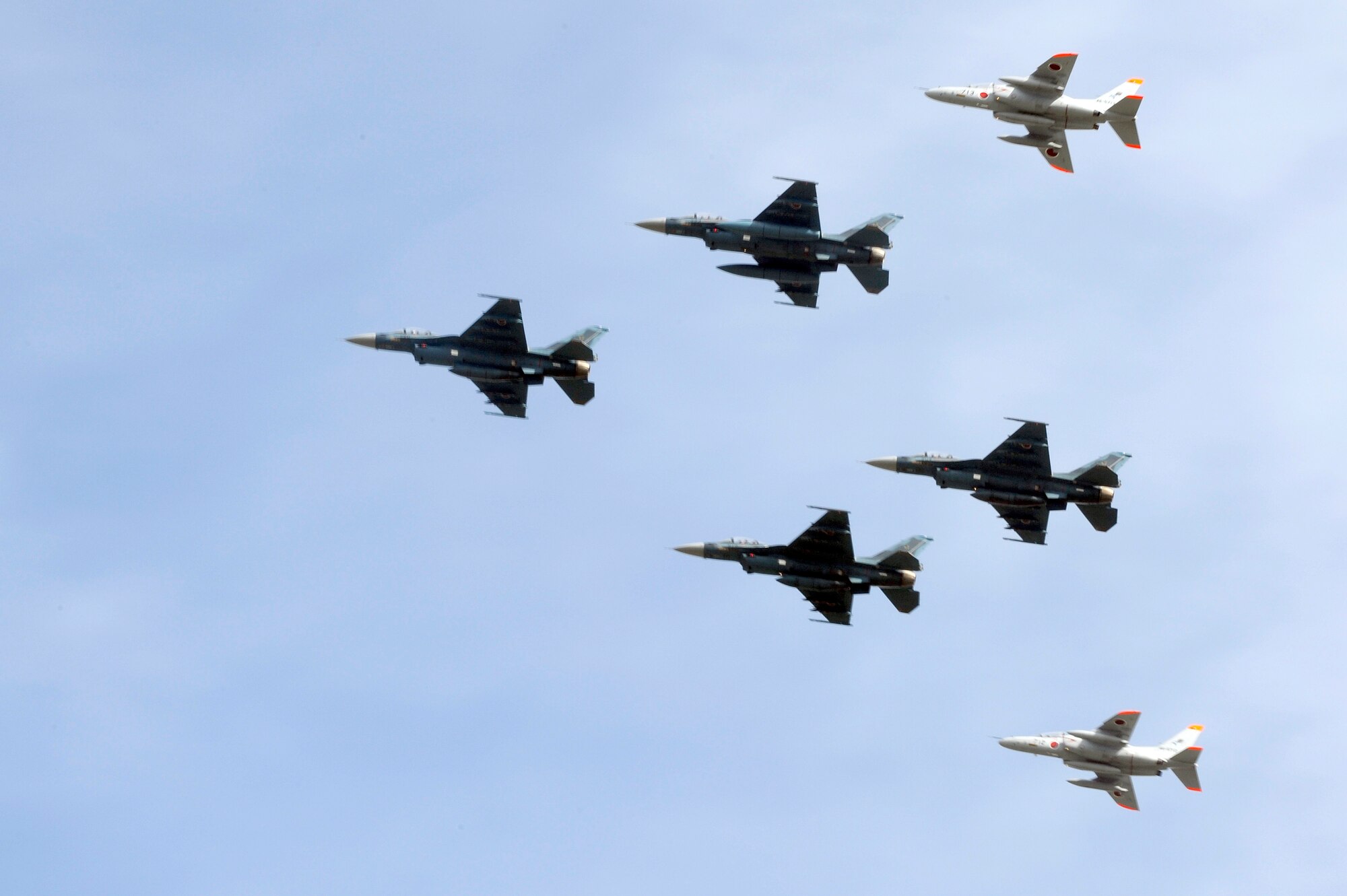 MISAWA AIR BASE, Japan - Four Japan Air Self-Defense Force F-2 and two JASDF T4 aircraft perform a fly-by during Misawa's 32nd-annual air fest Sept. 4. Air Fest 2011 was an opportunity for approximately 100,000 attendees to see eight aerial demonstrations with 19 static displays of JASDF, U.S. Air Force, U.S. Navy aircraft and private aircraft operators. Air Fest 2011 also marked the last flight of Miss Veedol, a single-engine aircraft that, in 1931, flew non-stop across the Pacific Ocean from Sabishiro Beach, Misawa, Japan to Wenatchee, Washington, U.S. (U.S. Air Force photo/Tech. Sgt. Marie Brown)
