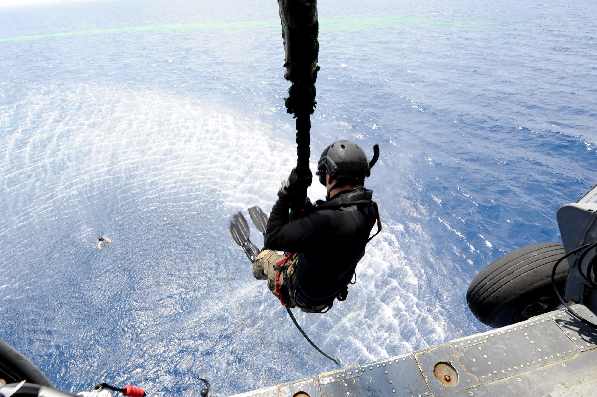 Brig. Gen. Matt Molloy, 18th Wing commander, jumps into the ocean during a joint field training exercise off the coast of Okinawa Sept. 1. The commander participated in the exercise with members from the 31st and 33rd Rescue Squadrons to get a first-hand experience of water survival, search and rescue, close air support, and maritime defense and interdiction. (U.S. Air Force photo/Airman 1st Class Jarvie Z. Wallace)
