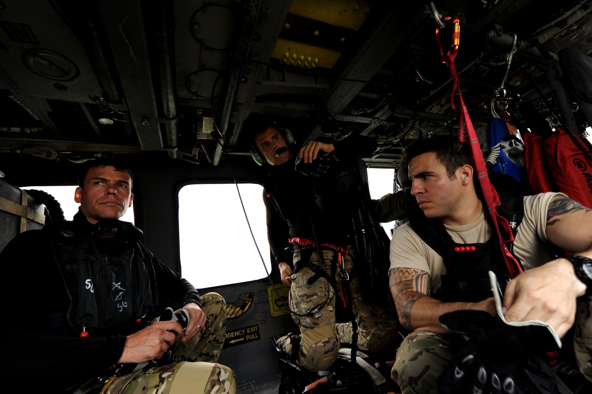 Brig. Gen. Matt Molloy, 18th Wing commander, along with Staff Sgts. Oliver Smith and Jacob Schaumberg, both 31st Rescue Squadron pararescuemen, prepare to jump into the ocean as part of a joint field exercise off the coast of Okinawa Sept. 1. The commander participated in the exercise with members from the 31st and 33rd Rescue Squadrons to get a first-hand experience of water survival, search and rescue, close air support, and maritime defense and interdiction. (U.S. Air Force photo/Airman 1st Class Jarvie Z. Wallace)