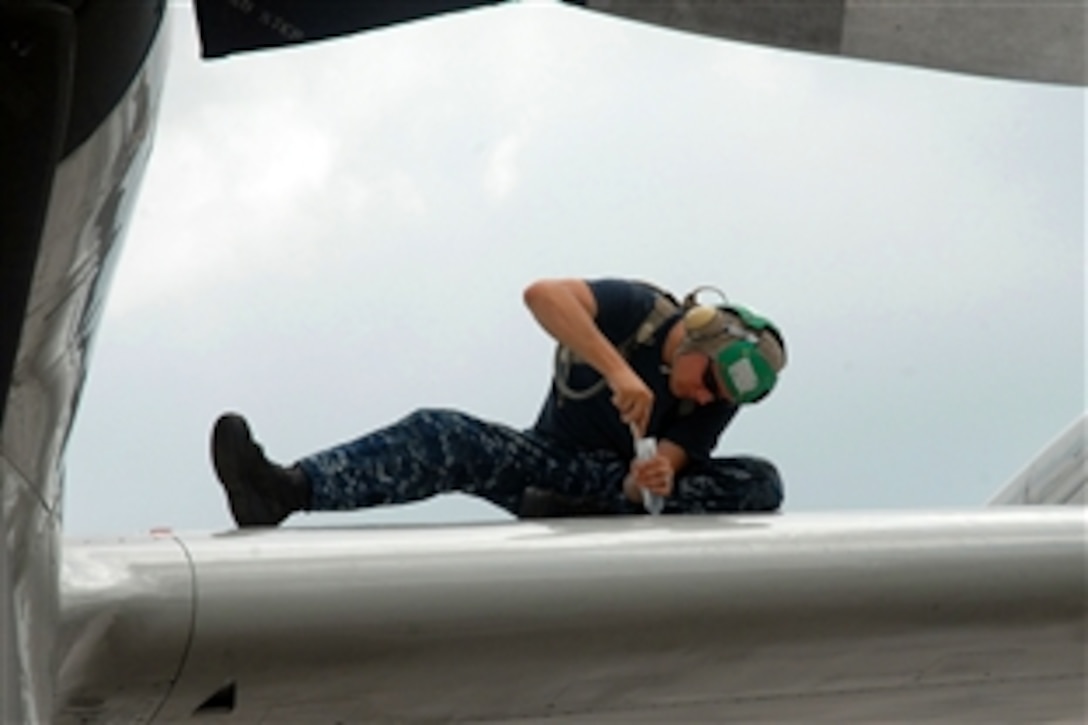 U.S. Navy Petty Officer 2nd Class Ruel Beck applies sealant to a leading edge wing panel of a P-3C Orion on Kadena Air Base in Okinawa, Japan, Sept. 6, 2011. Beck is a Aviation Structural Mechanic assigned to Patrol Squadron 40.