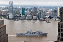 The crew of USS New York man the rails and present honors to the Ground Zero site, here, Sept. 8, as the ship arrives in Manhattan. The amphibious transport dock ship USS New York's crew will participate in numerous events throughout the city honoring the victims and responders from the Sept. 11 terrorist attacks. Onboard are, family members of victims and first responders from 9/11, along with the crew and Marines from 3rd Battalion, 9th Marine Regiment, based in Camp Lejeune, N.C. The ship was built with 7.5 tons of steel recovered from Ground Zero. The ship is scheduled to be pier side in Manhattan Sept. 8-9 and will anchor in the Hudson River Sept. 10-12. On Sept. 11, the USS New York will move from its anchorage in the Hudson River to a location within sight of the World Trade Center.