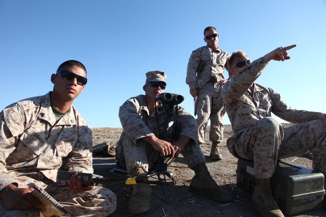 Enhanced combat skills instructors from Headquarters Company, Combat Logistics Regiment 17, 1st Marine Logistics Group, call-for-fire at a forward observation point during a mortar shoot at Camp Pendleton, Calif., Sept. 7. The shoot was a joint exercise with Company K, 3rd Battalion, 1st Marine Regiment, 1st Marine Division, mortar men.