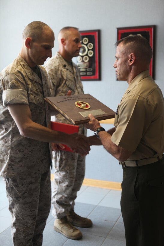 Brig. Gen. Thomas A. Gorry, Marine Corps Installations East commanding general, present the Warrior Preservation Award to Col. Daniel Lecce, Marine Corps Base Camp Lejeune commanding officer during an awards ceremony held at Base Safety aboard MCB Camp Lejeune, Sept. 8. This award is presented each fiscal year to the Marine Corps installation that has established the most comprehensive safety program.