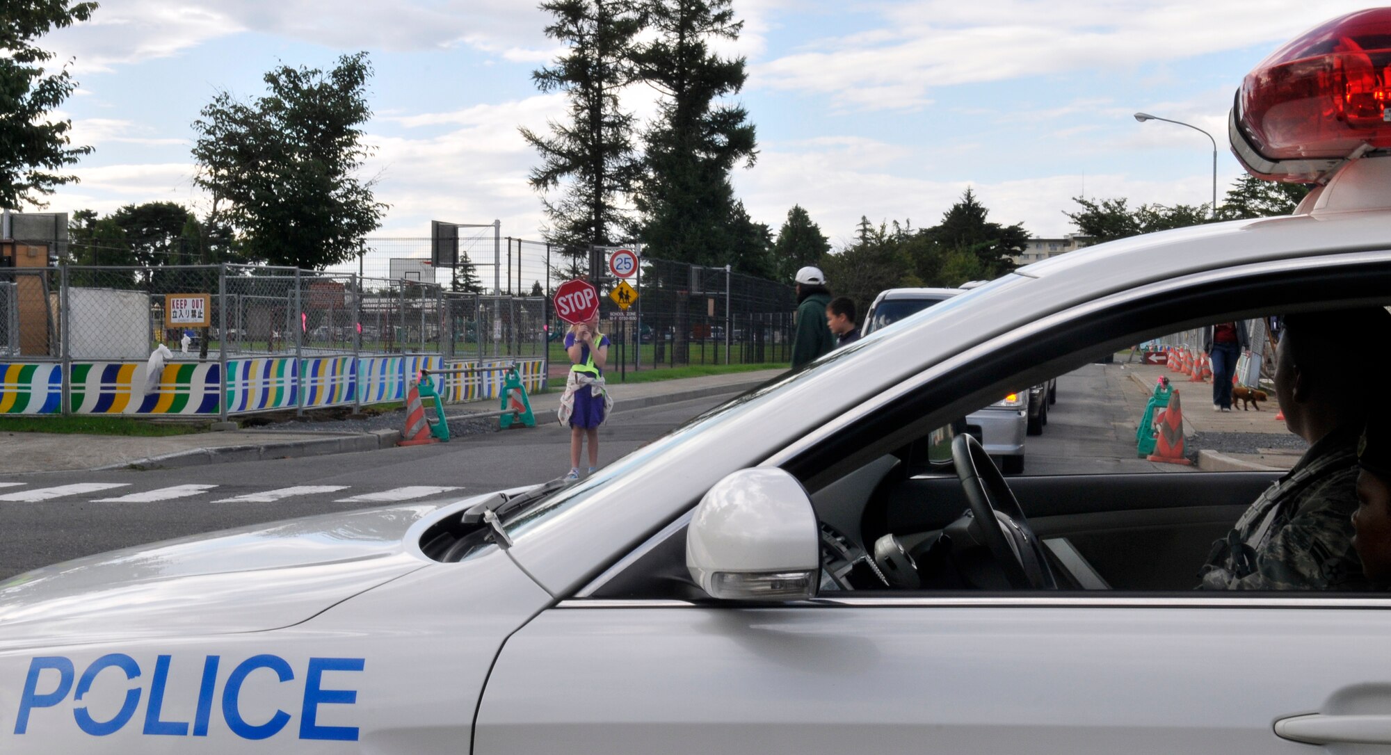 MISAWA AIR BASE, Japan – Senior Airman Reshelle Watson and Airman 1st Class Antonio Vallejos, 35th Security Forces Squadron patrolmen, provide over-watch for school zones and a deterrent for anyone speeding here Sept. 7. With school being back in session, base officials remind motorists to be aware of posted speed limits on base. (U.S. Air Force photo/Tech. Sgt. Phillip Butterfield)     