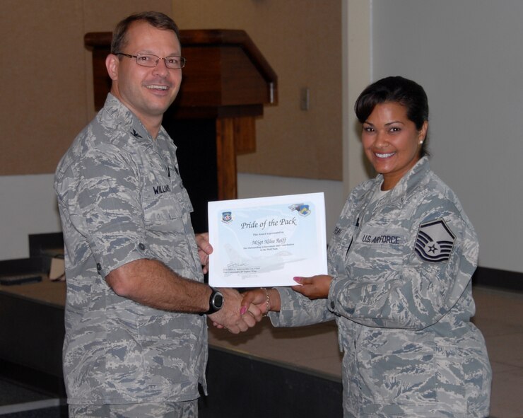 KUNSAN AIR BASE, Republic of Korea -- Col. Stephen C. Williams, 8th Fighter Wing vice commander, presents the Pride of the Pack award to Master Sgt. Nilsa Lisette Reiff, 8th Communications Squadron plans, programs and resources superintendent, here Sept. 8. (U.S. Air Force photo/Capt. Omar Villarreal)