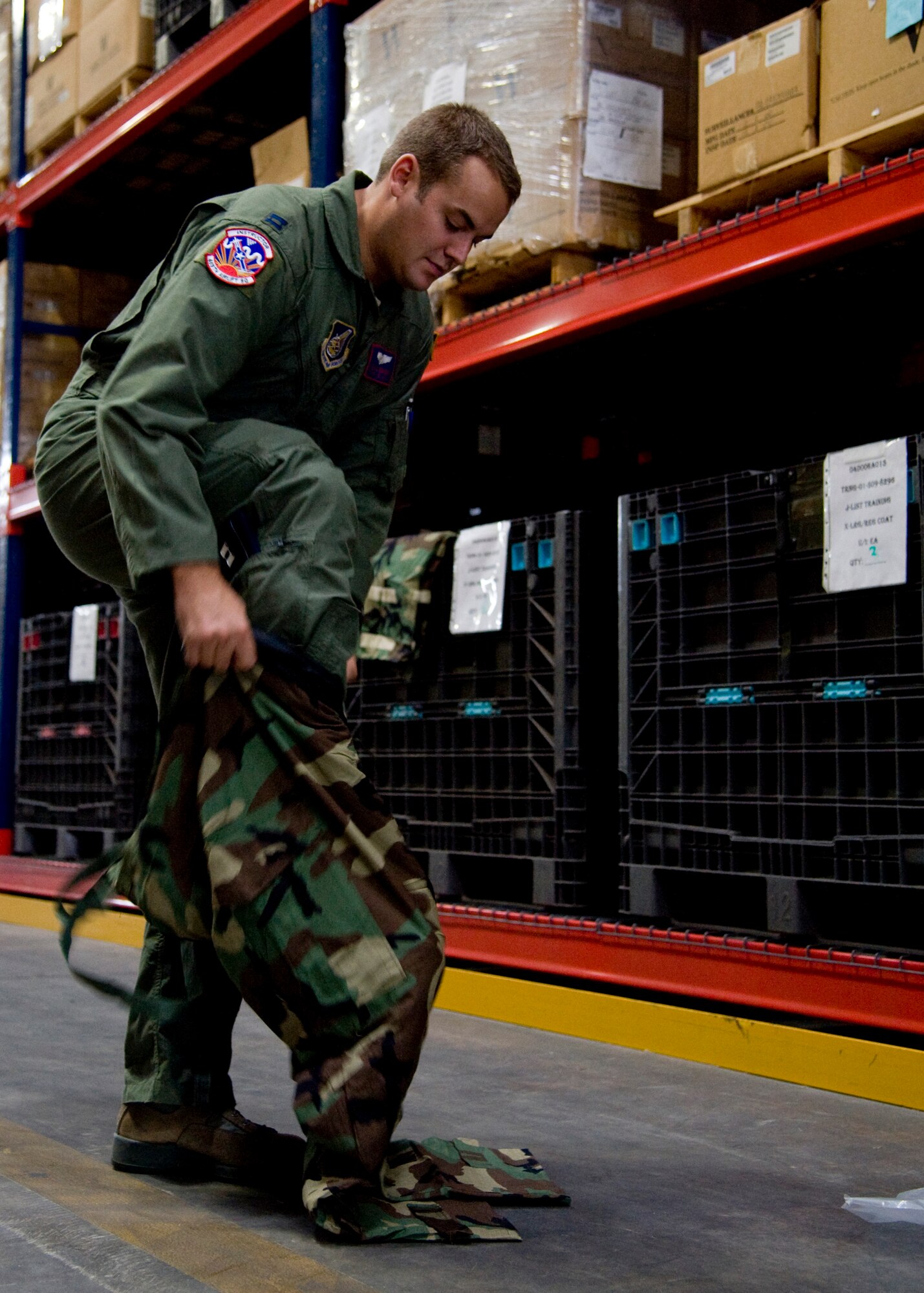 YOKOTA AIR BASE, Japan -- Capt. Michael Emery, 459th Airlift Squadron executive officer, tries on individual protective equipment at the 374th Logistics Readiness Squadron supply warehouse at Yokota Air Base, Japan, Sept. 6, 2011. Captain Emery was issued new gear in preparation for Yokota's upcoming operational readiness exercise. (U.S. Air Force photo/Senior Airman Andrea Salazar)