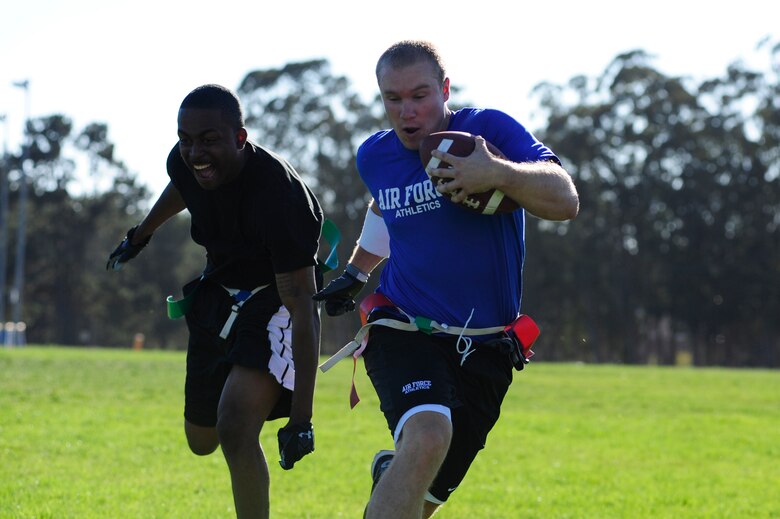 VANDENBERG AIR FORCE BASE, Calif. – Staff Sgt. Darrin Tullis, of the 30th Security Forces Squadron, narrowly misses grabbing 2nd Lt. Brad Pingel’s flags during a flag football tournament at the base track field here Wednesday, Sept. 8, 2011. The 30th SFS took the game with a 26 to 21 victory over the 392nd TRS. (U.S. Air Force photo/Senior Airman Lael Huss)