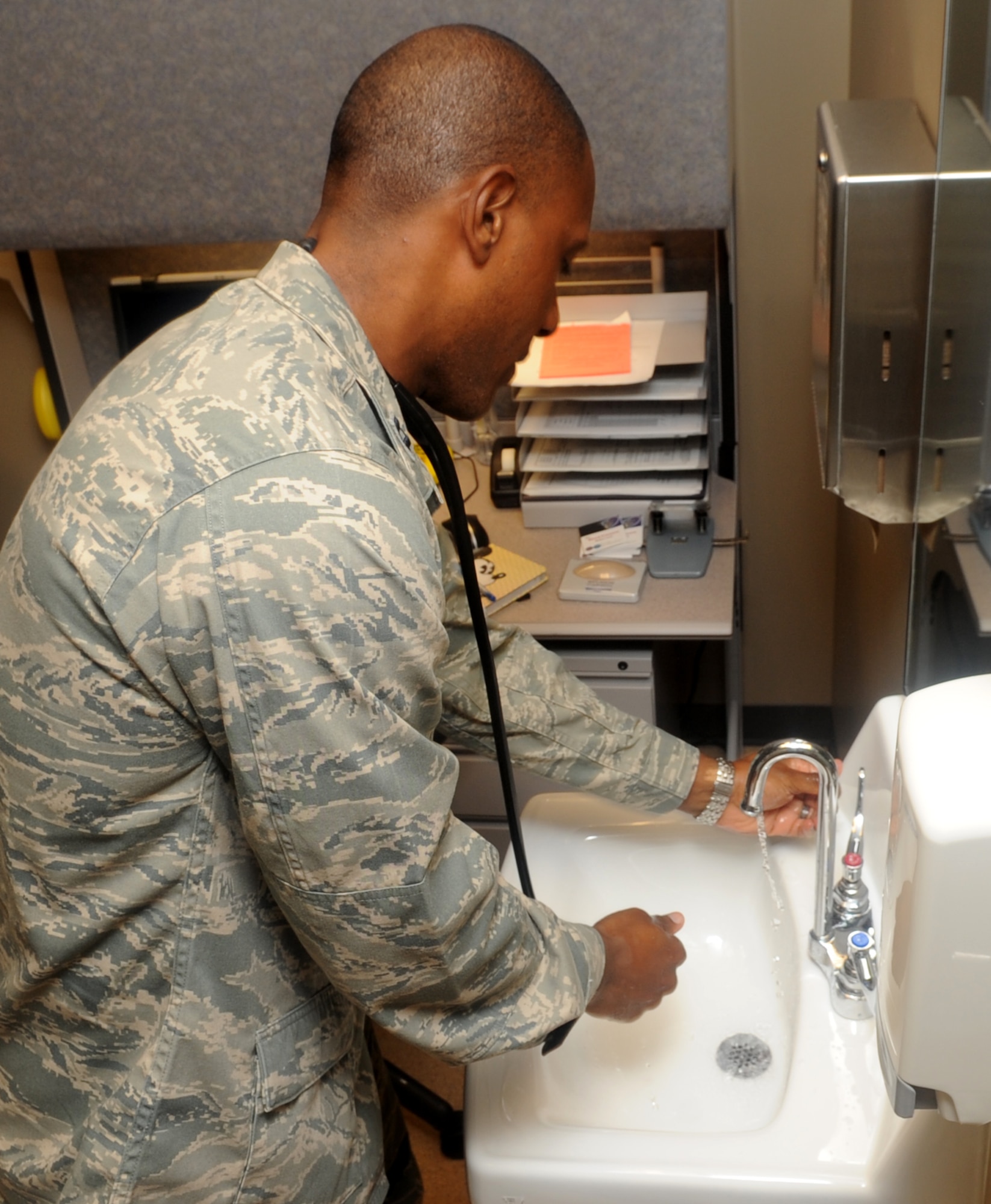 Capt. Mark Dudley, 2nd Medical Operations Squadron, washes his hands before examining a patient on Barksdale Air Force Base, La., Sept 8. It's important for doctors to wash their hands before and after seeing patients to prevent spreading infections. (U.S. Air Force photo/Senior Airman Kristin High) (RELEASED)