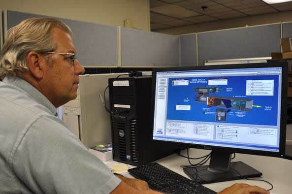 Michael Miller, a 92nd Civil Engineer Squadron Energy Management Control Systems operator, evaluates one of three EMCS here Aug. 31. He was awarded the U.S. Federal Energy Management Program’s 2011 Federal Energy and Water Management Award for Exceptional Service Aug. 3. (U.S. Air Force photo/Scott King)
