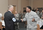 Col. William H. Mott V, former 37th Training Wing commander, is congratulated by Command Chief Master Sgt. Jay Simon soon after his selection ceremony as an honorary chief master sergeant. Simon was Mott’s top enlisted advisor during his tenure as commander of the 37 TRW. (U.S. Air Force photo/Alan Boedeker)
