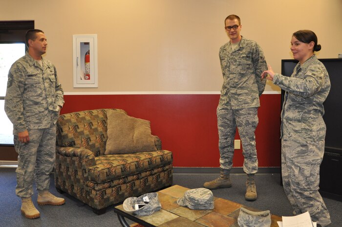 Chief Master Sgt. Max Grindstaff, 75th Air Base Wing and Ogden Air Logistics Center command chief, listens Aug. 24 to Airman 1st Class Audrey Carlstrom, 75th Aerospace Medicine Squadron and Hill Air Force Base Honor Guard member, and Airman 1st Class Jacob Wilson, 75th AMDS, as they review renovations Airmen volunteers have made to the Junior Enlisted Club. These include new paint, new set-up with the televisions and game systems, as well as plans for a possible movie theater and wi-fi. (U.S. Air Force photo by Senior Airman Melissa Dearstone)