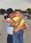 Airman Basic Daniela Negrete hugs her 4-year-old son, Seth, soon after becoming a naturalized U.S. citizen Aug. 25 during the Airman’s coin ceremony at Lackland. Negrete, originally from Mexico and a resident of Oxnard, Calif., and four other basic trainees are the first Airmen to become naturalized U.S. citizens while attending Air Force Basic Military Training. (U.S. Air Force photo/Alan Boedeker)