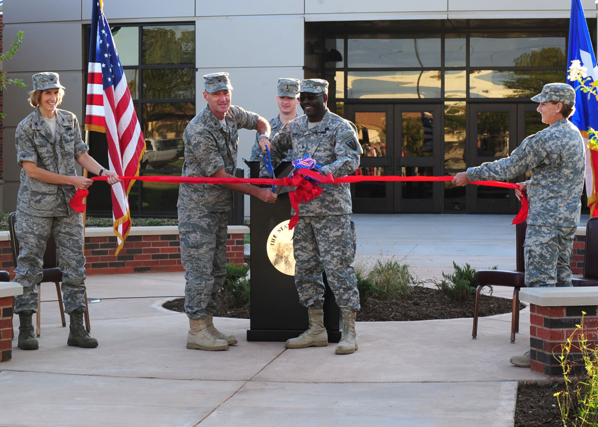 Col. David Been, 7th Bomb Wing commander, and Brig. Gen. Lester Simpson, 176th Engineer Brigade Commander, cut the ribbon Sept. 8, 2011 during the official grand opening of the new Armed Forces Reserve Center at Dyess Air Force Base, Texas. The multi-use facility is part of the larger realignment of base facilities across the United States. Locally, the AFRC personnel could support missions on Dyess, the local community and the greater state of Texas. (U.S. Air Force Photo by Senior Airman Chelsea Browning/ Released)