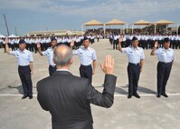 U.S. Citizenship and Immigration Services Associate Director Donald Monica administers the Oath of Allegiance to five basic trainees Aug. 25.  The trainees, from left to right, Jared Garcia, from the Philippines; Ariful Haque, Bangladesh; Louise Quinsay, Philippines; Kurt Danggoec, Philippines; and Daniela Negrete, Mexico, are the first Airmen to become U.S. citizens while attending Air Force Basic Military Training. (U.S. Air Force photo/Alan Boedeker)