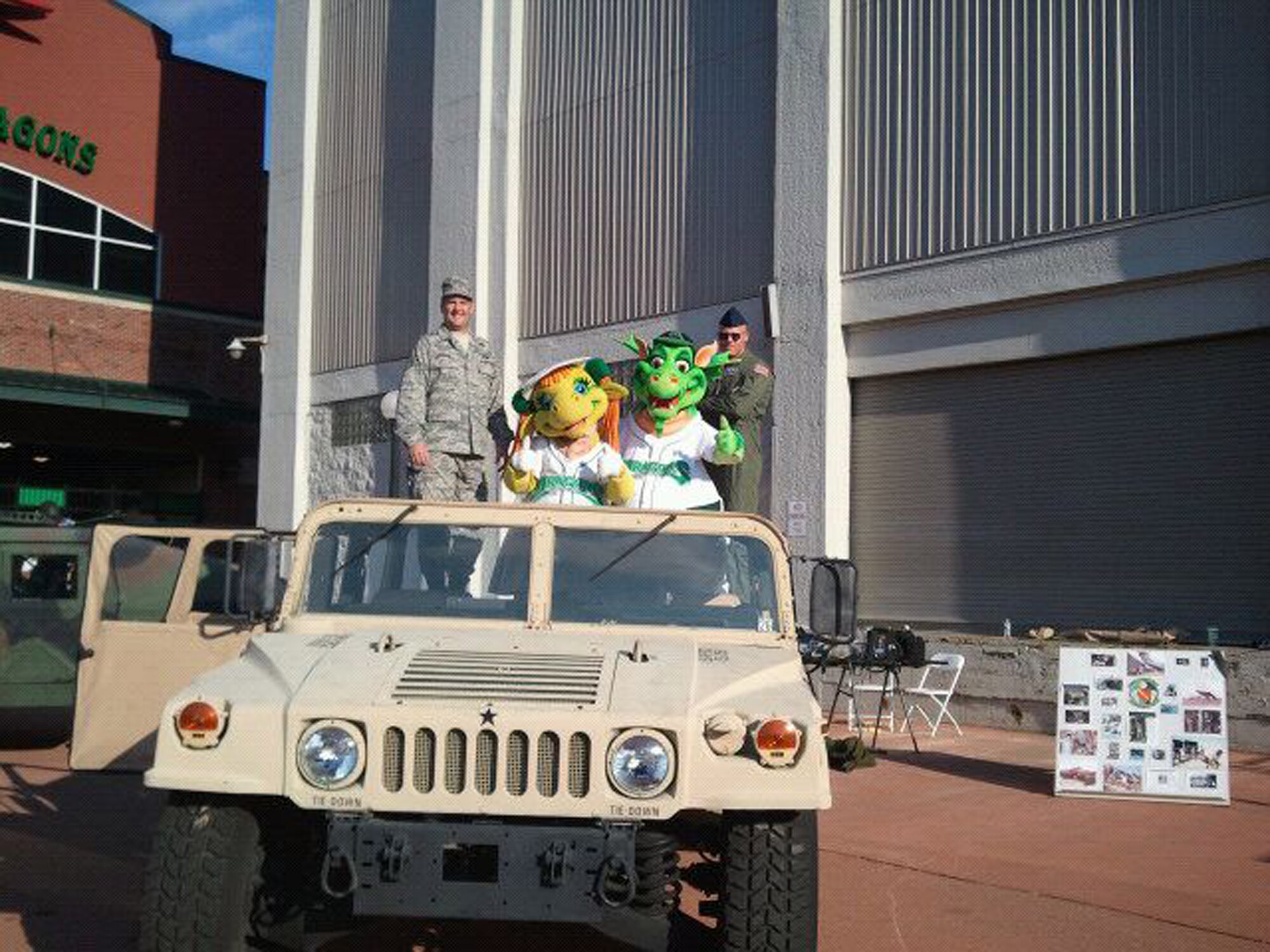 WRIGHT-PATTERSON AIR FORCE BASE, Ohio – On the left, Master Sgt. Tom Shannon and Tech. Sgt. Nathan Hutchinson, both from the 445th Aeromedical Evacuation Squadron, pose with Dayton Dragon’s minor league baseball mascots Gem and Heater during the Hometown Heroes Celebration Night Aug. 27 at Fifth Third Field. (Courtesy photo)