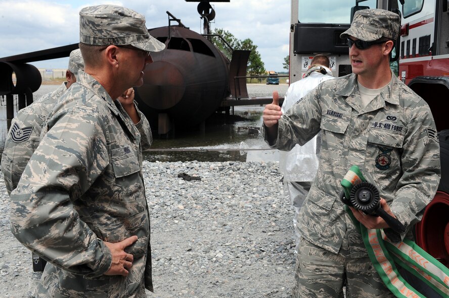 U.S. Air Force Senior Airman Gregory Verbiski, 23rd Civil Engineer Squadron, describes parts of a fire engine to Maj. Gen. Stephen Hoog, 9th Air Force commander, at Moody Air Force Base, Ga., Sept. 8, 2011. Hoog took part in the demonstration to get a better understanding of fire fighter capabilities at Moody. (U.S. Air Force photo by Senior Airman Ciara Wymbs/Released) 