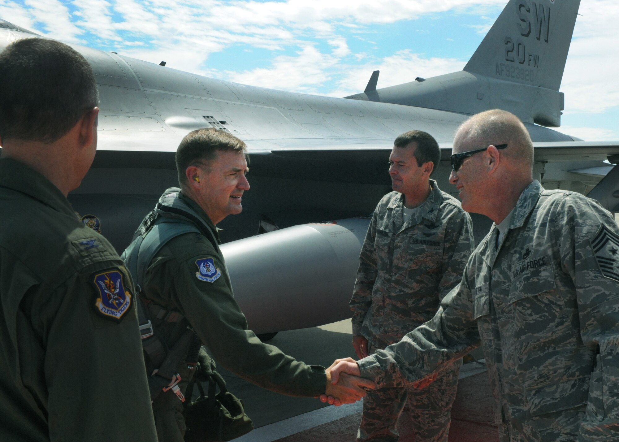 U.S. Air Force Maj. Gen. Stephen Hoog, 9th Air Force commander, shakes hands with Chief Master Sgt. Frank Batten, 23rd Wing command chief, after arriving to Moody Air Force Base, Ga., Sept. 7, 2011. Hoog was also welcomed by Col. Billy Thompson, 23rd Wing commander, Col. Scott Kindsvater, 93d Air Ground Operations Wing (AGOW) commander, and Chief Master Sgt. Atticus Smith, 93d AGOW command chief.  (U.S. Air Force photo by Airman 1st Class Douglas Ellis/Released)
