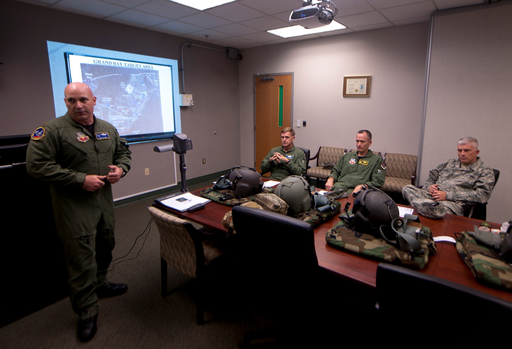 U.S. Air Force Maj. Kirk Adams, 41st Rescue Squadron HH-60G Pave Hawk pilot, gives Maj. Gen. Stephen Hoog, 9th Air Force commander, Col. Billy Thompson, 23rd Wing commander and Chief Master Sgt. Robert Brooks, 9th Air Force command chief, a flight briefing before departing to Grand Bay during Hoog’s base visit at Moody Air Force Base, Ga., Sept. 7, 2011. Adams explained the course of the flight and what weapons they’ll be using during the flight. (U.S. Air Force photo by Airman 1st Class Joshua Green/Released)
