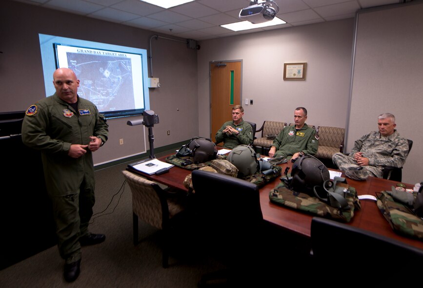 U.S. Air Force Maj. Kirk Adams, 41st Rescue Squadron HH-60G Pave Hawk pilot, gives Maj. Gen. Stephen Hoog, 9th Air Force commander, Col. Billy Thompson, 23rd Wing commander and Chief Master Sgt. Robert Brooks, 9th Air Force command chief, a flight briefing before departing to Grand Bay during Hoog’s base visit at Moody Air Force Base, Ga., Sept. 7, 2011. Adams explained the course of the flight and what weapons they’ll be using during the flight. (U.S. Air Force photo by Airman 1st Class Joshua Green/Released)
