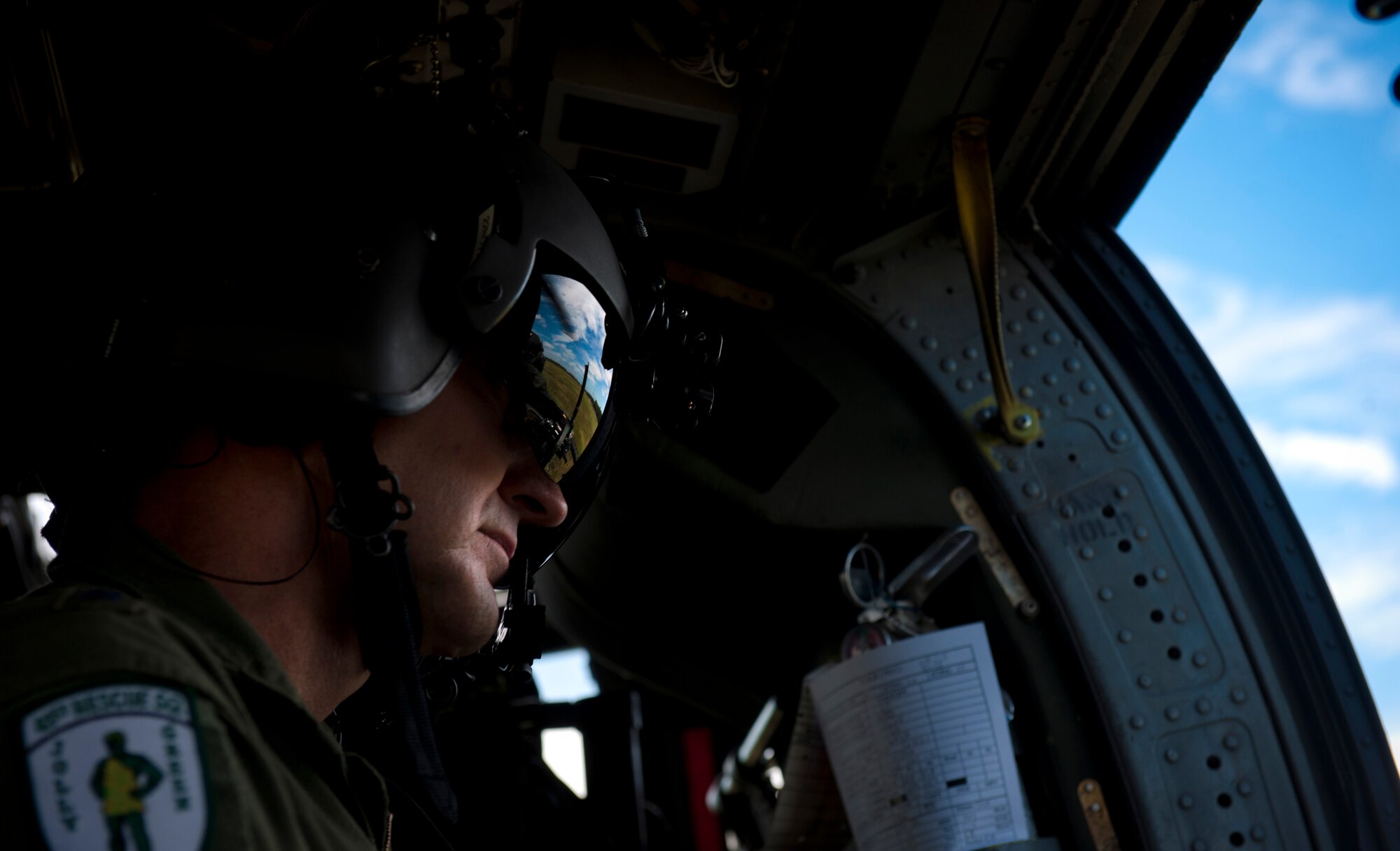 U.S. Air Force Maj. Gen. Stephen Hoog, 9th Air Force commander, looks out the window of an HH-60G Pave Hawk during his visit to Moody Air Force Base, Ga., Sept. 7, 2011. Hoog flew to the Grand Bay Bombing and Gunnery Range and fired a GAU-2/A 7.62mm minigun while flying on the aircraft. (U.S. Air Force photo by Airman 1st Class Joshua Green/Released)
