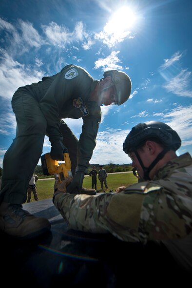 U.S. Air Force Maj. Gen. Stephen Hoog, 9th Air Force commander, uses a saw to cut open a roof during a rescue demonstration with the 38th Rescue Squadron at Moody Air Force Base, Ga., Sept. 7, 2011. Hoog visited different agencies on base to get a first-hand look at their mission capabilities. (U.S. Air Force photo by Airman 1st Class Joshua Green/Released)
