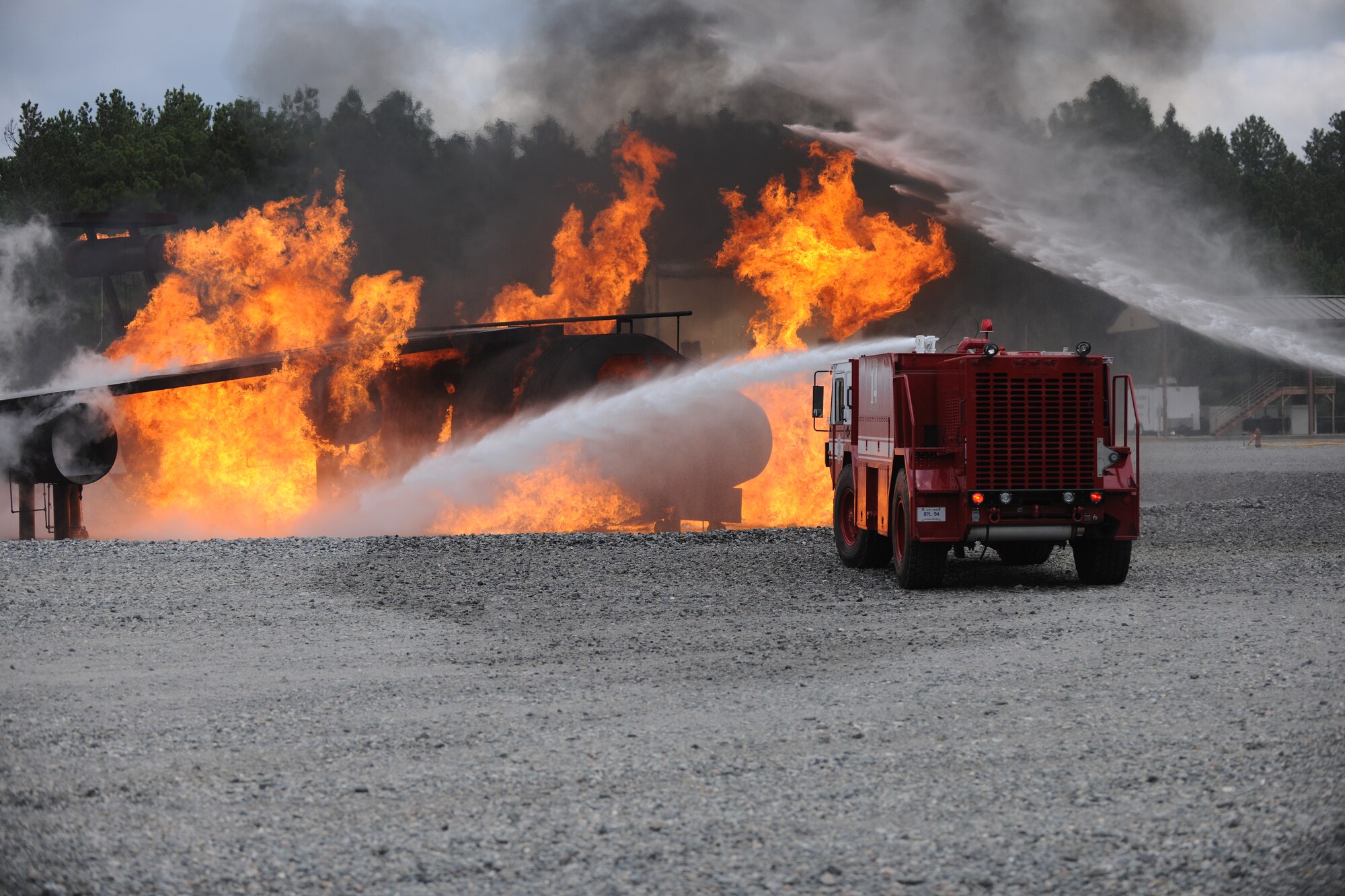 U.S. Air Force Maj. Gen. Stephen Hoog, 9th Air Force commander, helps hose down a simulated fire at Moody Air Force Base Ga., Sept. 8, 2011. Hoog participated in the fire pit demonstration during his visit with the 23rd Civil Engineer Squadron. (U.S. Air Force photo by Airman 1st Class Paul Francis/Released)
