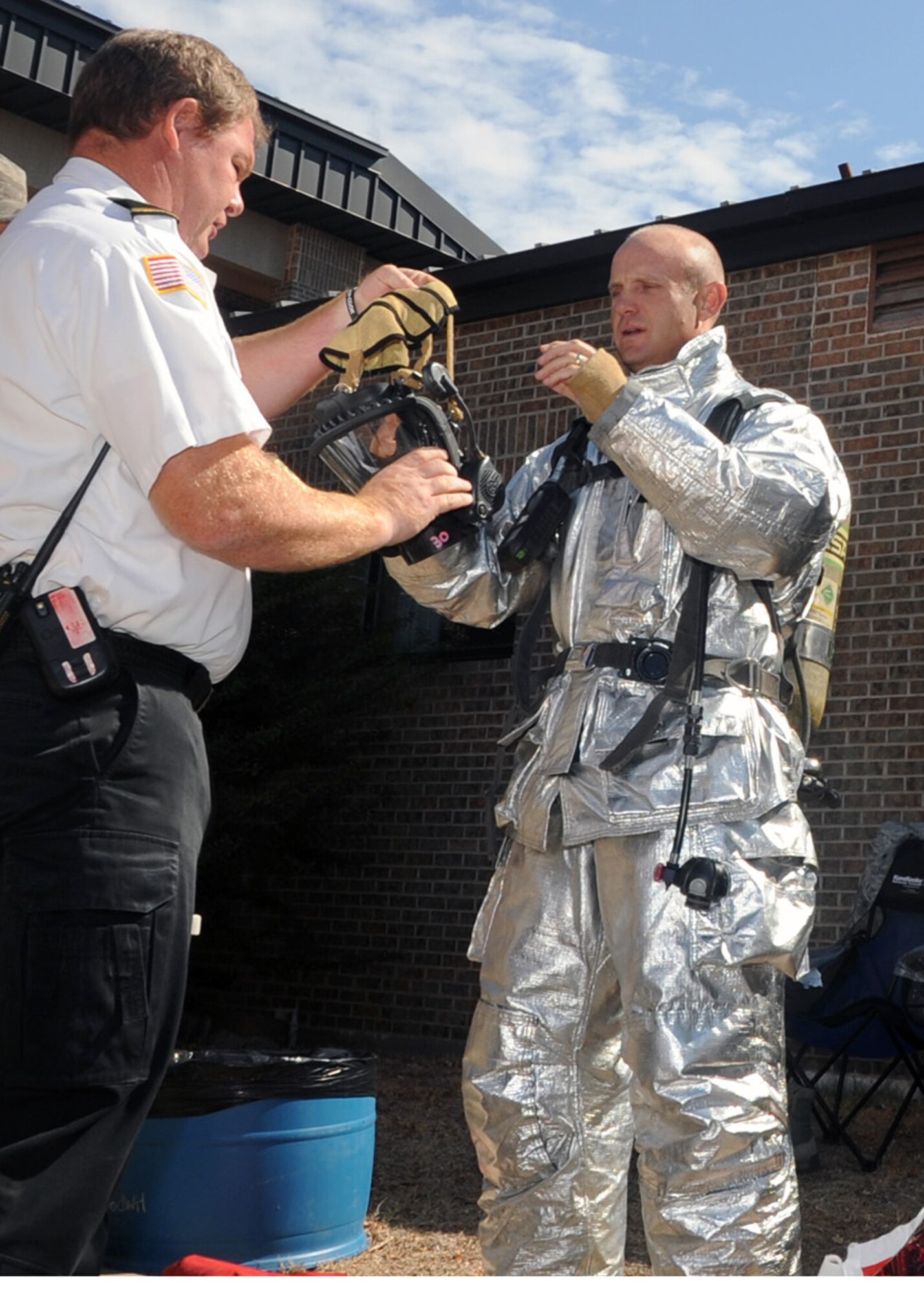 ALTUS AIR FORCE BASE, Okla. – Col. Anthony B. Krawietz, 97th Air Mobility Wing commander, prepares to don an oxygen mask during a demonstration performed by 97th Civil Engineer Squadron firefighters at building 333 Sept. 8, 2011. During the demonstration Col. Krawietz donned a firefighter suit to learn firsthand what it is like to rescue a person from a smoky room. (U.S. Air Force photo by Airman 1st Class Kenneth W. Norman / Released / 97th Air Mobility Wing Public Affairs)