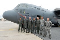 Crew members of the final flight of C-130E #63-7868, line up for a photo in front of the aircraft. U. S. Air Force photo by Sue Sapp