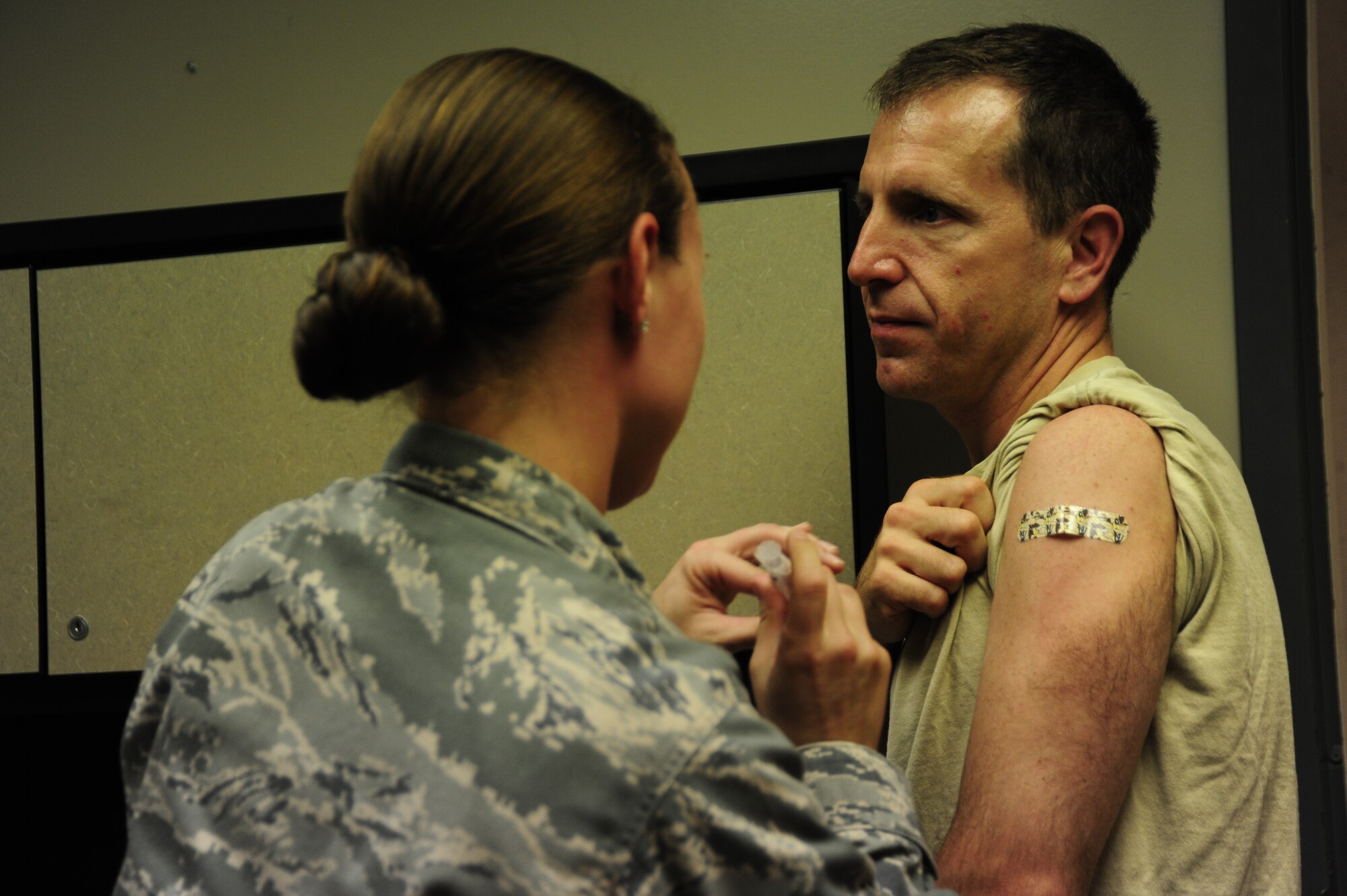 Col. James Slife, 1st Special Operations Wing commander receives a flu vaccination administered by Staff Sgt. Sheri Sellers, 1st Special Operations Medical Operations Squadron, at the medical group building at Hurlburt Field, Fla., Sept. 6, 2011.  Vaccinations are available at the clinic weekdays between 7:30 AM until 12:00 PM and 1:00 PM until 4:30 PM.  (U.S. Air Force photo by Amn Naomi M. Griego/ Released)       