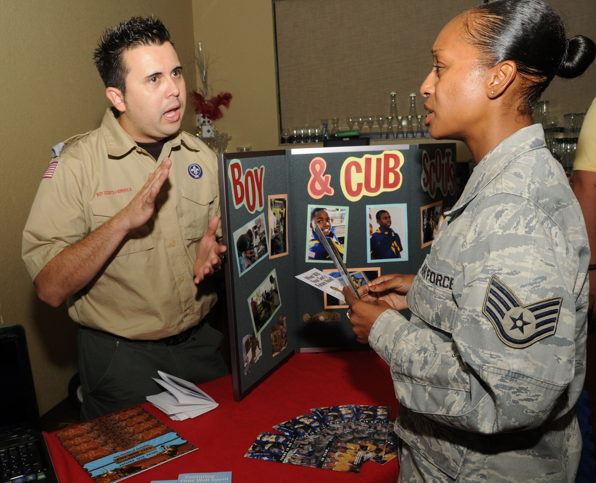Rafael Sanchez, district executive for the Boy Scouts of America, discusses Scouting programs with Staff Sgt. Tanisha West, 81st Training Support Squadron, at the regional Combined Federal Campaign kickoff breakfast Sept. 1 at the Bay Breeze Event Center.  (U.S. Air Force photo by Kemberly Groue)