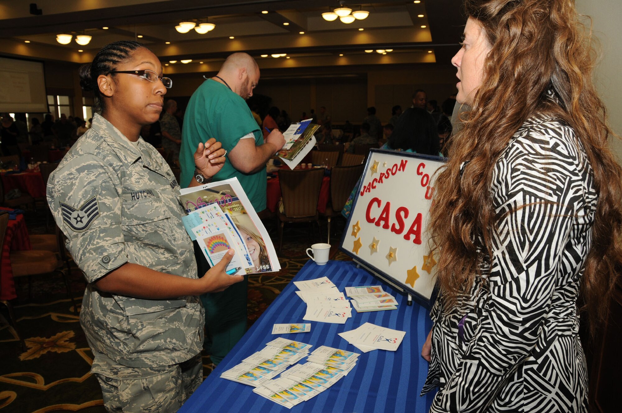 Staff Sgt. Makela Hutchins, left, 81st Medical Operations Squadron, talks to Shelly Ferguson, a volunteer with Court Appointed Special Advocates in Jackson County, during the Sept. 1 kickoff breakfast for the regional Combined Federal Campaign.  CASA volunteers are child advocates in court cases.  (U.S. Air Force photo by Kemberly Groue)
