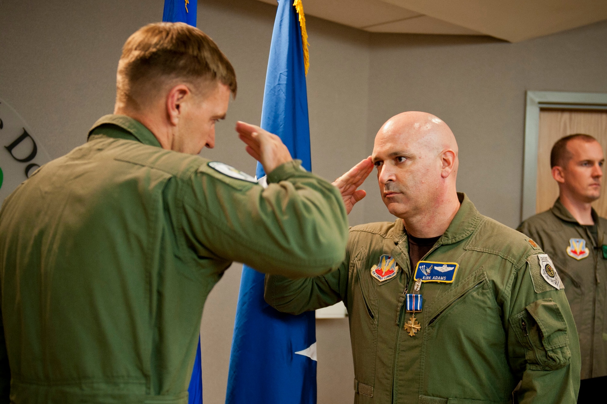 U.S. Air Force Maj. Kirk Adams, 41st Rescue Squadron HH-60 pilot, renders a salute to Maj. Gen. Stephen Hoog, 9th Air Force commander, during a Distinguished Flying Cross Medal with valor presentation at Moody Air Force Base, Ga., Sep. 7, 2011. Various members of Adams’ unit and leadership attended the ceremony to support and congratulate him for his accomplishment. (U.S. Air Force photo by Staff Sgt. Jamal D. Sutter/Released)
