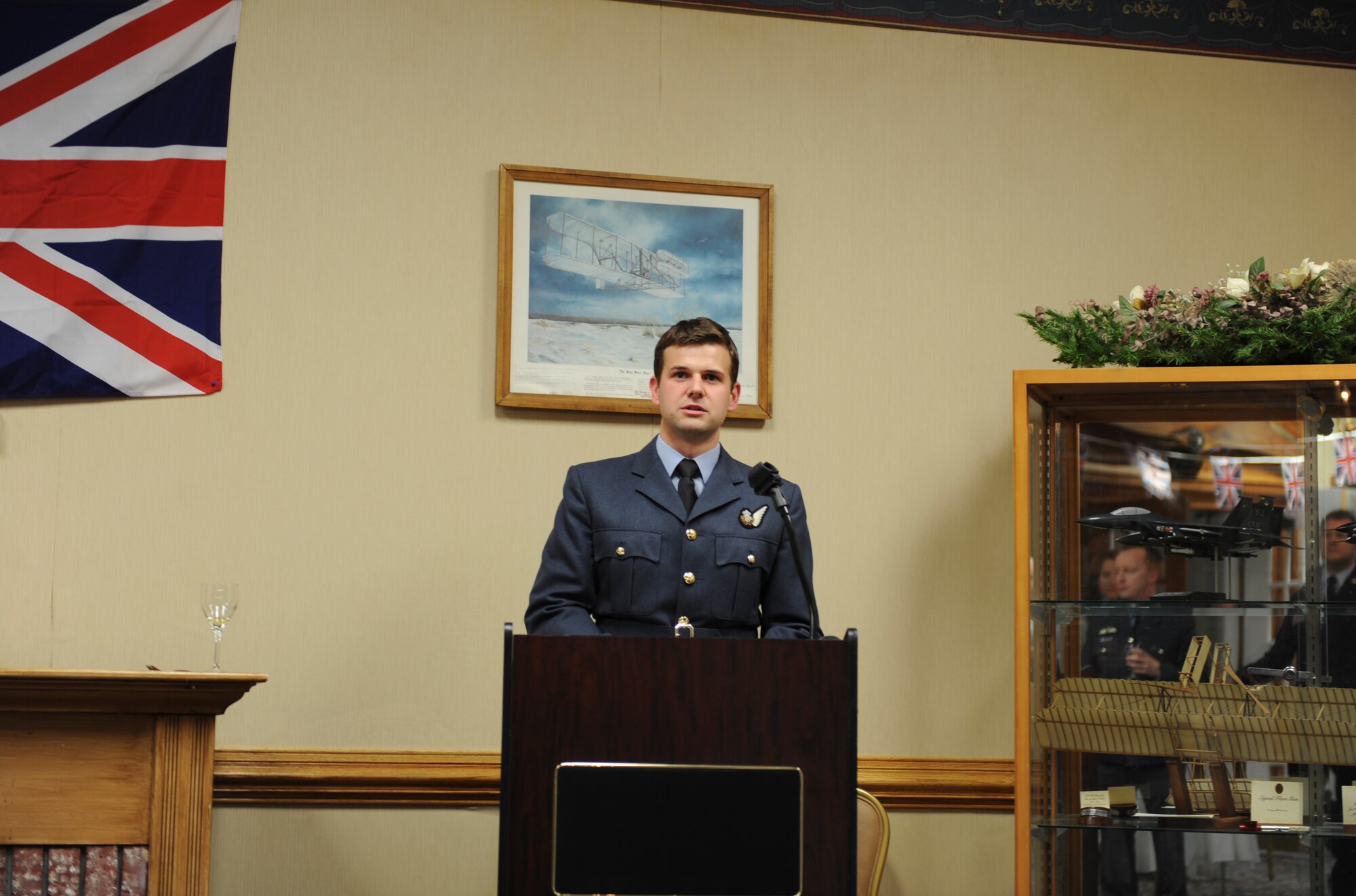 Royal Air Force Flight Lt. Edward Whitechurch speaks during the social hour preceding the Battle of Britain celebration at Heritage Hall on Seymour Johnson Air Force Base, N.C., Sept. 1.  The celebration is a yearly event held to commemorate the anniversary of the Battle of Britain during World War II.  The event was organized by Whitechurch and other officers to commemorate the 71st anniversary of the epic battle.  Whitechurch is a RAF exchange weapons system officer assigned to the 335th Fighter Squadron.  (U.S. Air Force photo by 2nd Lt. Keavy Rake/Released)