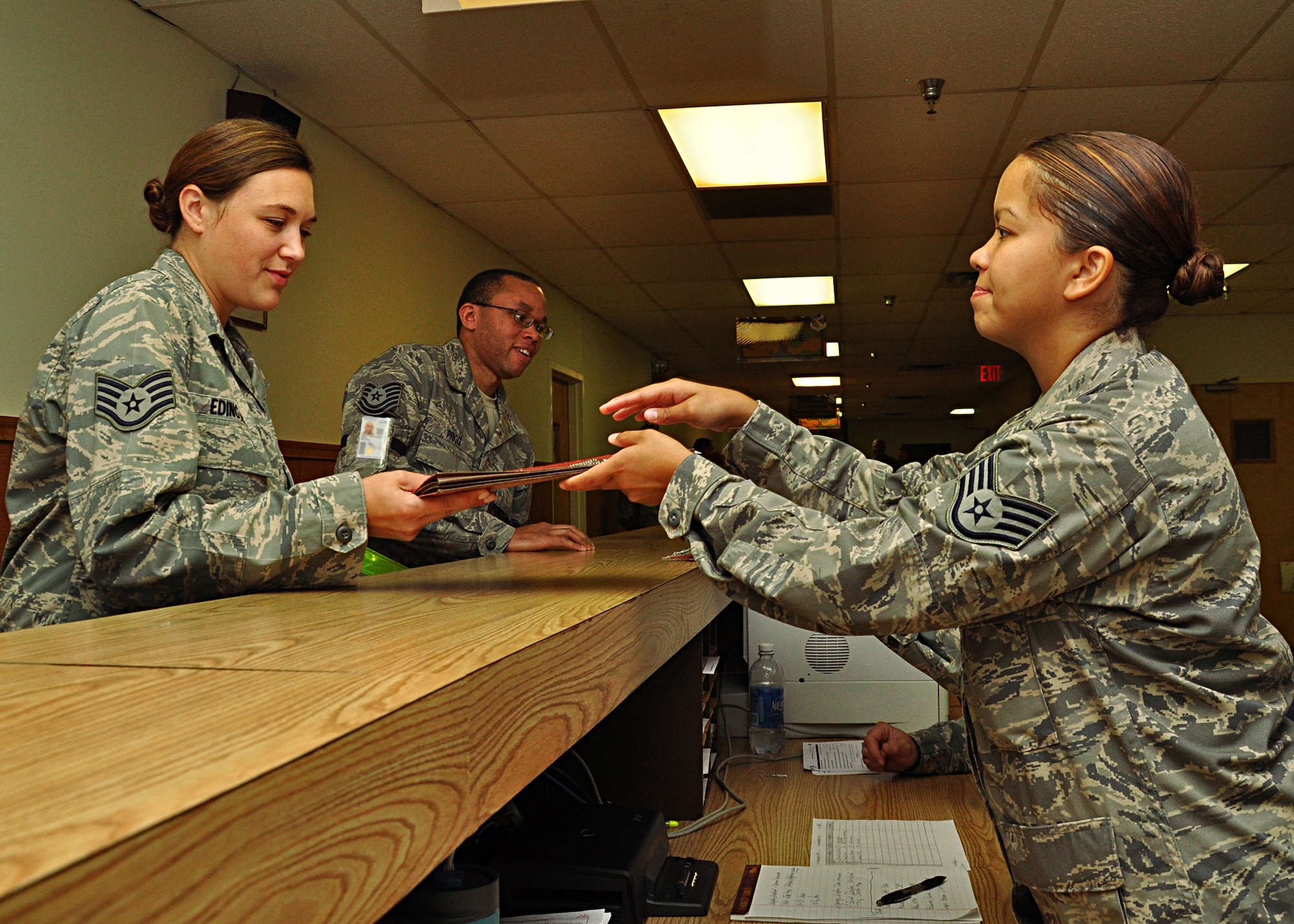 WRIGHT-PATTERSON AIR FORCE BASE, Ohio - Staff Sgt. Priscilla Murphy, 445th Force Support Squadron, checks Staff Sgt. Jennifer Edington's, 445th Aeromedical Evacuation Squadron, mobility folder and dog tags for accuracy during the wing's deployment exercise Aug. 6 to 7. (U.S. Air Force photo/Senior Airman Mikhail Berlin)