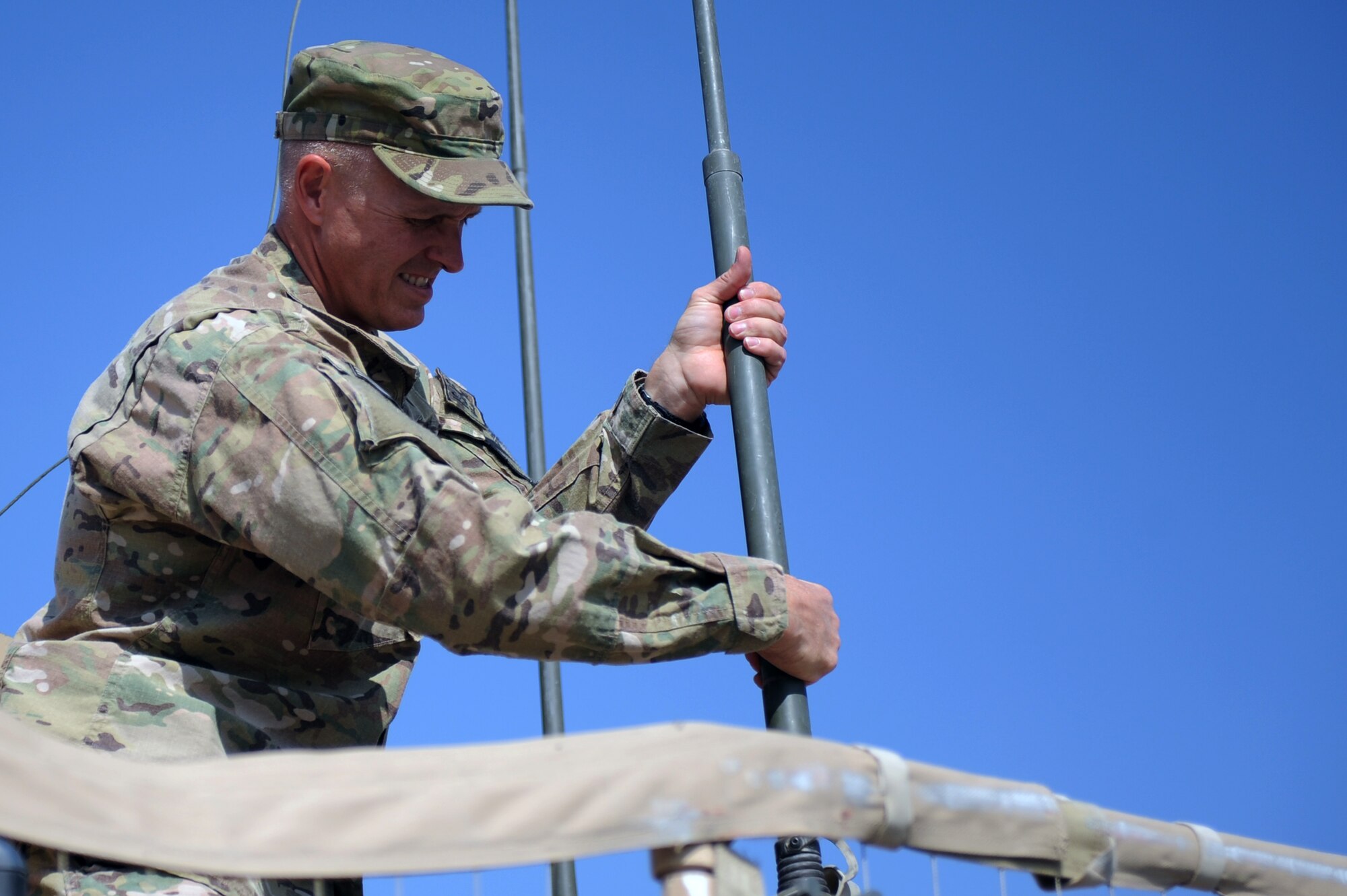 U.S. Air Force Master Sgt. Alex Kruhlinski, performs post mission maintenance on the radio antennas of a mine resistant vehicle at Forward Operating Base Nejrab in Afghanistan's Kapisa Province. Kruhlinski left a successful civilian career to join the U.S. Air Force after the events of 9/11. (Photo by U.S. Air Force Staff Sgt. Jason Huddleston, Kapisa Provincial Reconstruction Team Public Affairs)