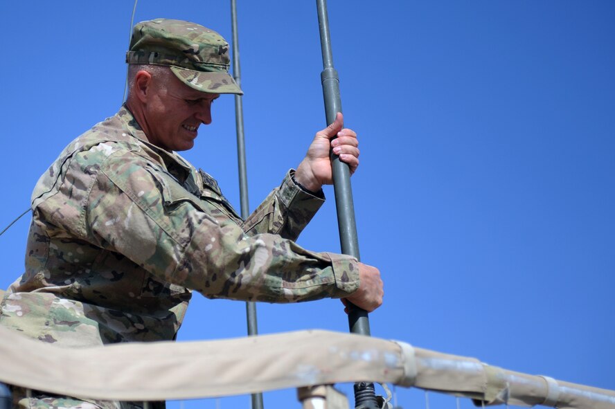 U.S. Air Force Master Sgt. Alex Kruhlinski, performs post mission maintenance on the radio antennas of a mine resistant vehicle at Forward Operating Base Nejrab in Afghanistan's Kapisa Province. Kruhlinski left a successful civilian career to join the U.S. Air Force after the events of 9/11. (Photo by U.S. Air Force Staff Sgt. Jason Huddleston, Kapisa Provincial Reconstruction Team Public Affairs)
