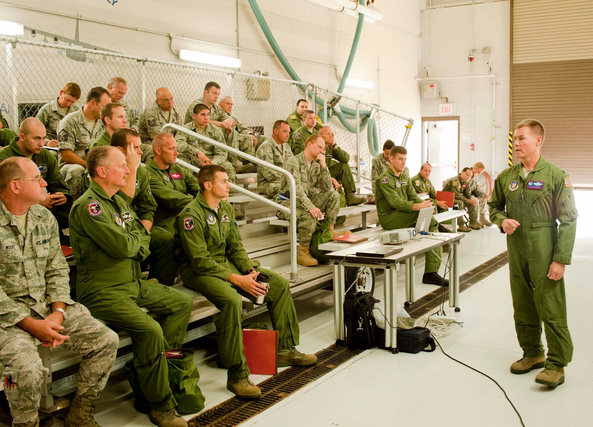 Air Force Reserve Col. Craig Peters, commander of the 910th Operations Group, briefs a group of aircrew, support and maintenance Citizen Airmen preparing to deploy here, Sept. 1, 2011. The 910th Military Personnel Flight and Logistics Readiness Squadron organized a mass out-processing to streamline the logistics of preparing them for deployment. The Airmen are scheduled for a 120-day mission to the Southwest Asia theater of operations.