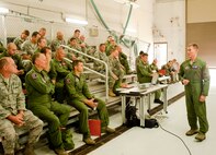Air Force Reserve Col. Craig Peters, commander of the 910th Operations Group, briefs a group of aircrew, support and maintenance Citizen Airmen preparing to deploy here, Sept. 1, 2011. The 910th Military Personnel Flight and Logistics Readiness Squadron organized a mass out-processing to streamline the logistics of preparing them for deployment. The Airmen are scheduled for a 120-day mission to the Southwest Asia theater of operations.