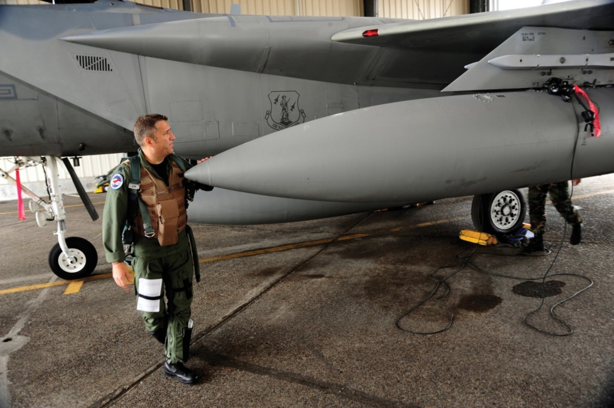 US Air Force Lt. Col. Steve Beauchamp of the 123rd Figther Squardron, 142nd Fighter Wing preformes a final preflight inspection before for a morning flight to Davis-Monthan Air Force Base on September 16th, 2009. Beauchamp will fly F-15A model aircraft tail number 77-098 to the “Bone Yard” and is the last active F-15A model airframe left in the Active Air Force inventory. (US Air Force photograph by Staff Sgt. John Hughel)