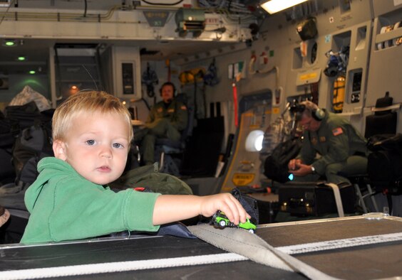 Two-year-old Marcus Erickson uses a cargo container as an obstacle for his toy truck during a flight aboard a 729th Airlift Squadron C-17 Globemaster III to March Air Reserve Base, Calif., Aug. 30, 2011. (U.S. Air Force photo/ Master Sgt. Linda Welz)